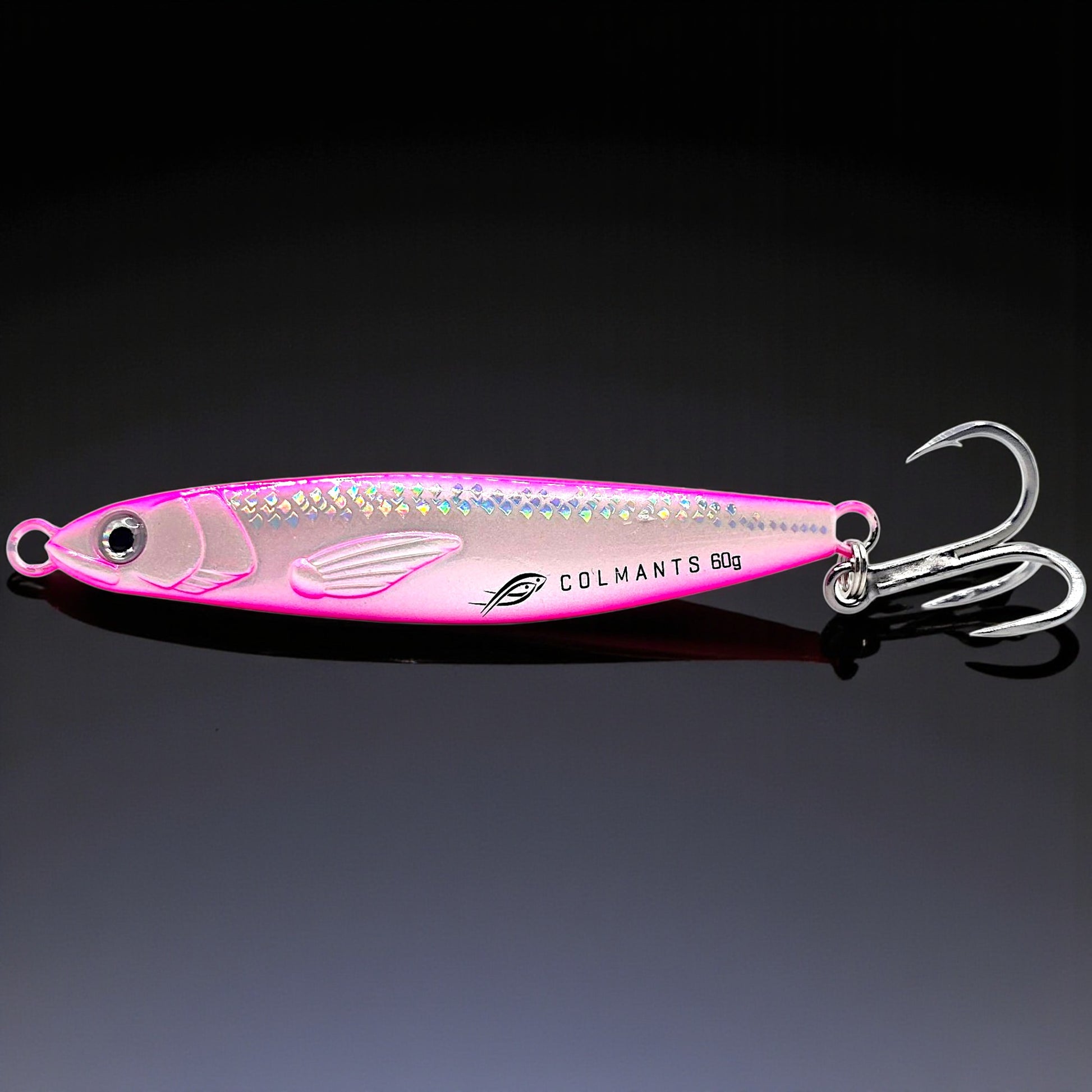 Pink fishing lure with a hook on a dark background