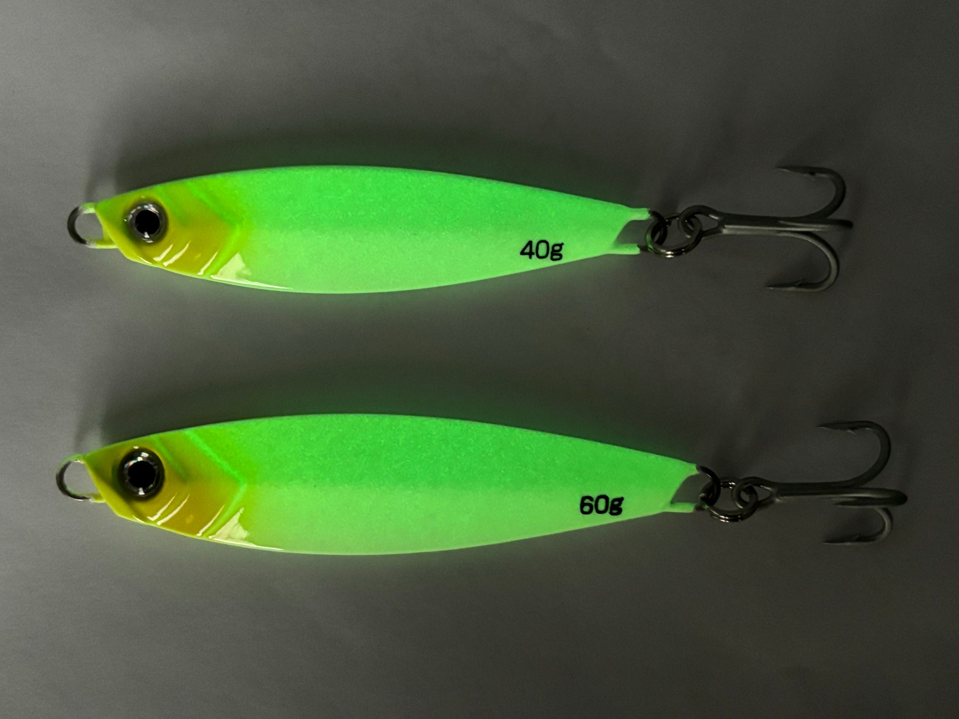 Castman Casting Minnow White/Yellow. Showing low light glow. Best saltwater fishing lure at night. Long casting jig